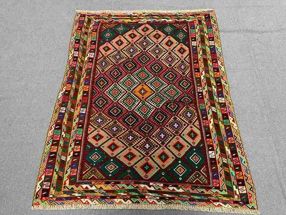 3.2x4 ft tribal kilim rug placed in a cozy living room setting