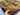 Handmade 4x7 multicolor Afghan patchwork rug held in hand showing wool weave