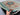 5x7 handmade Mamluk rug in red and green held in hands – close look at artisan craftsmanship