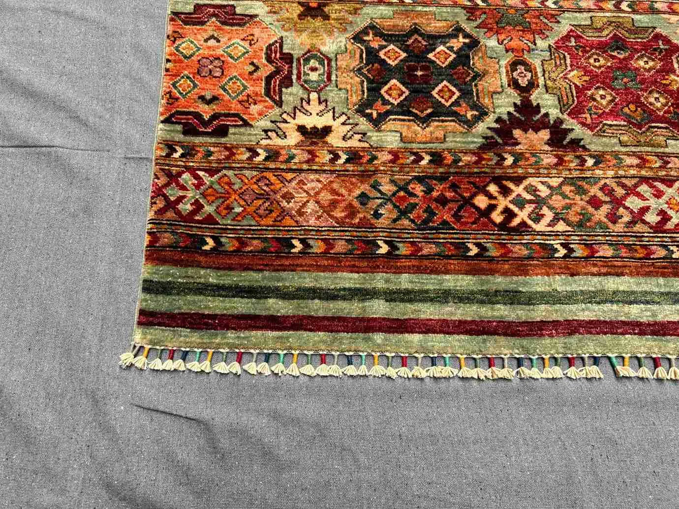 Corner detail of 5x7 tribal wool carpet – vibrant bohemian design