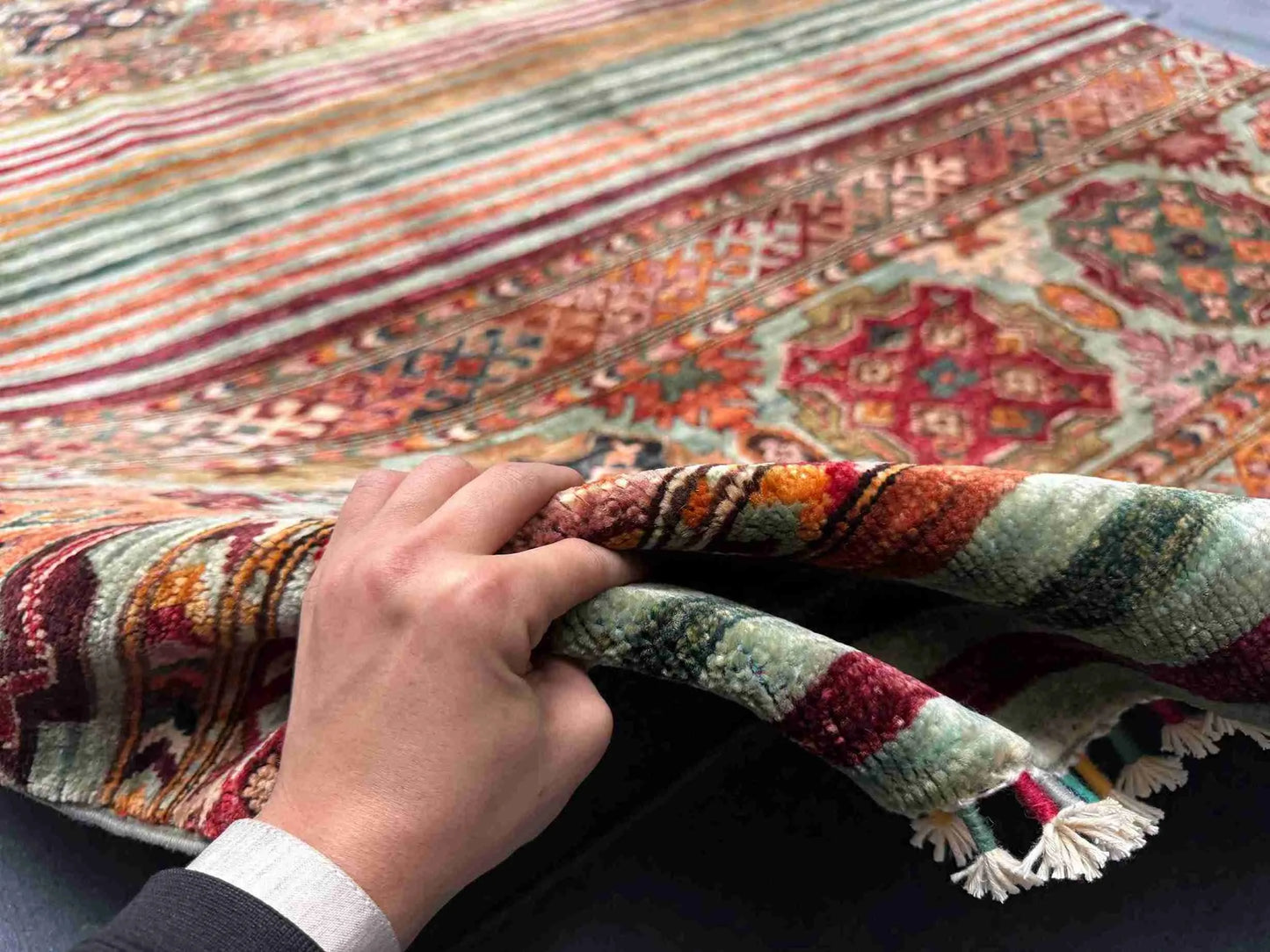 Handmade 5x7 Tribal Wool Rug in hands – front view of red Khorjin carpet
