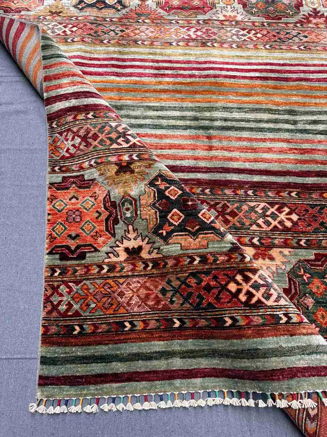 Folded front view of 5x7 handmade tribal Khorjin wool rug