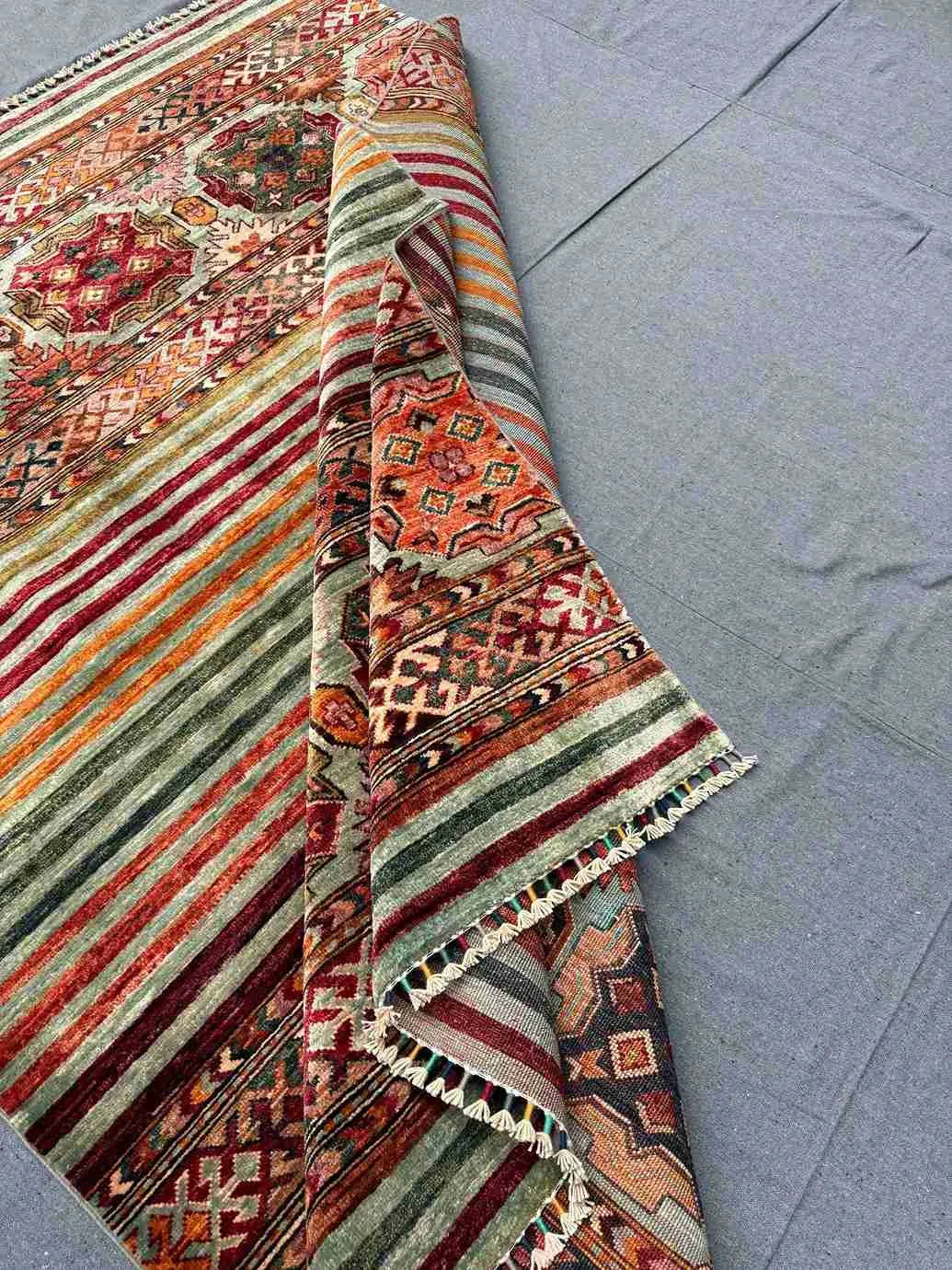 Folded front view of 5x7 handmade tribal Khorjin wool rug