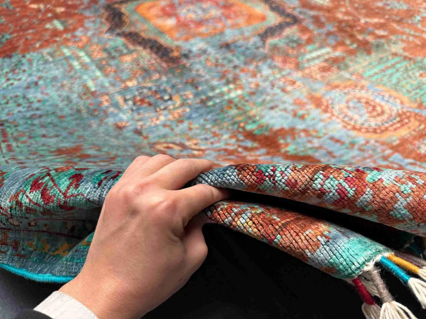Front view of 5x8 multicolor Mamluk rug held by hand