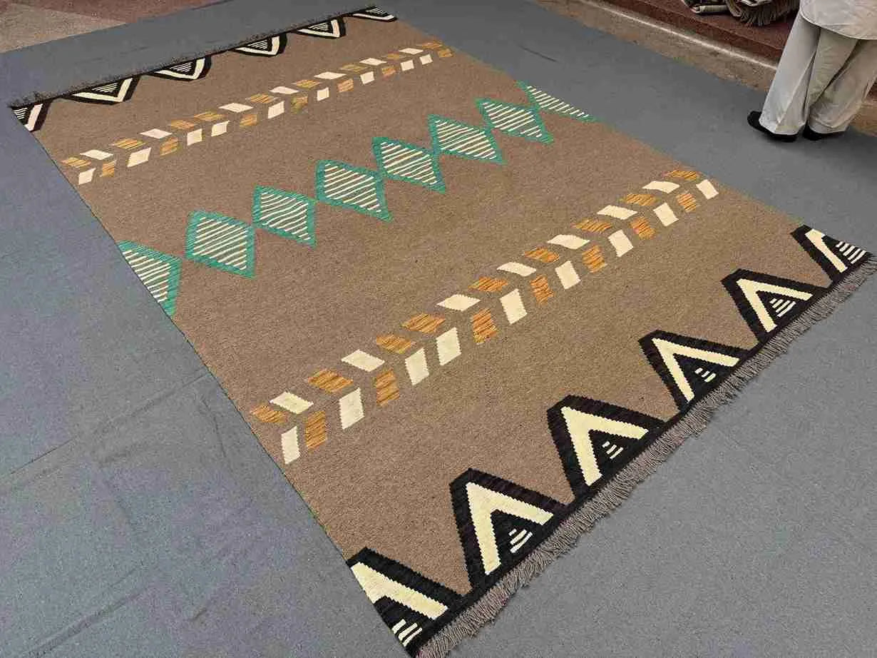 Side-angle view of 6x9 Kilim rug on floor highlighting texture.