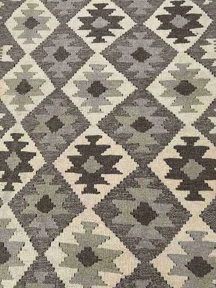 Close-up of earthy toned Kilim runner rug weave texture