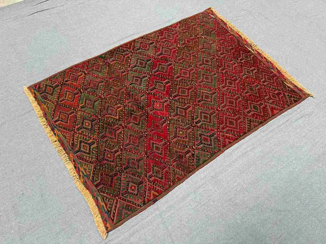 Red tribal kilim rug in a boho interior room setup