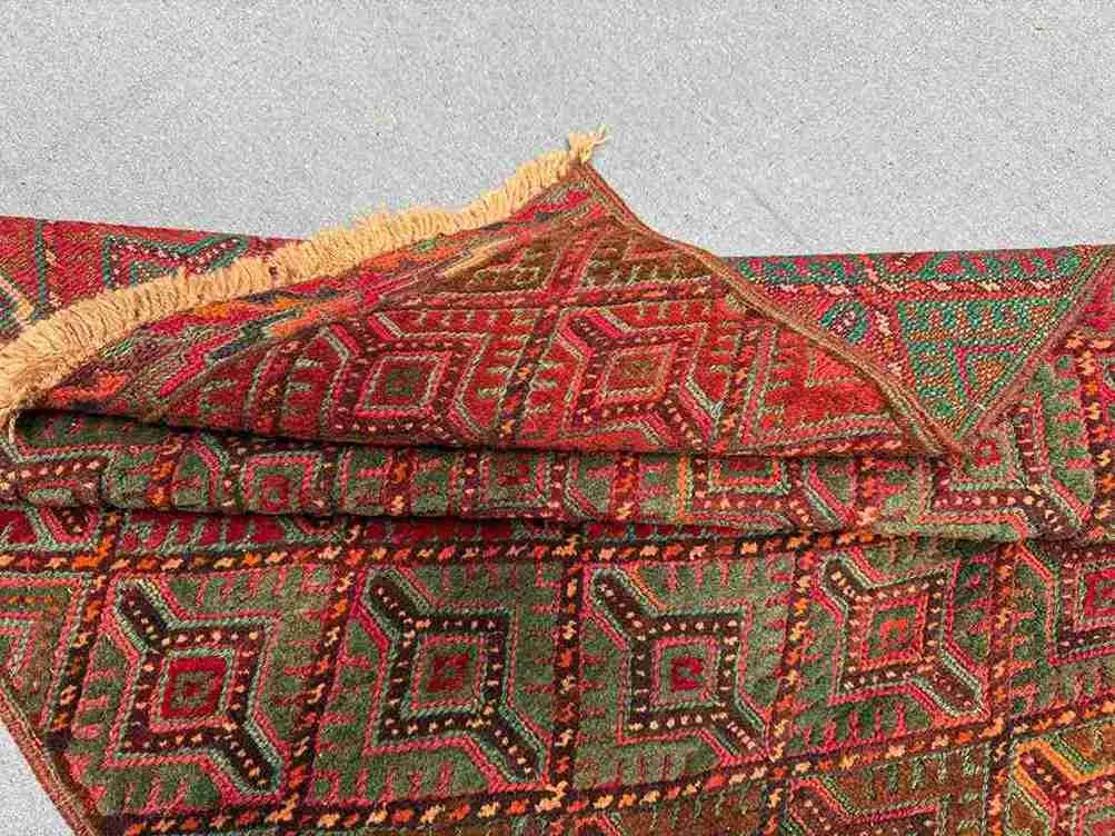 Folded handmade Afghan wool rug showing thickness and softness