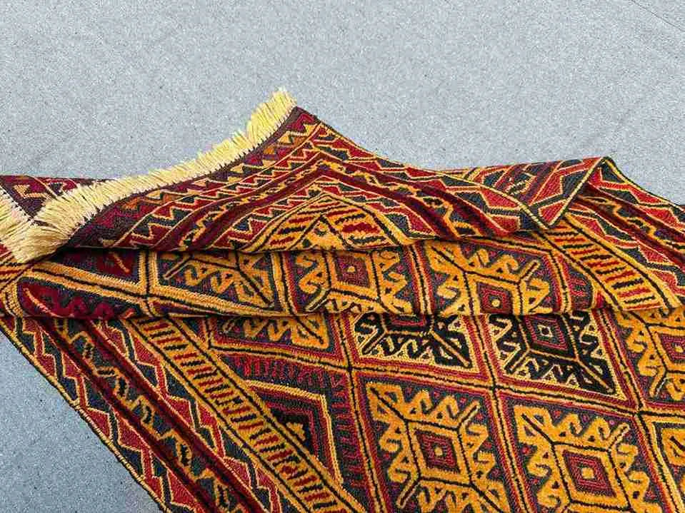 Folded view of Afghan kilim rug showing vintage handwoven craftsmanship