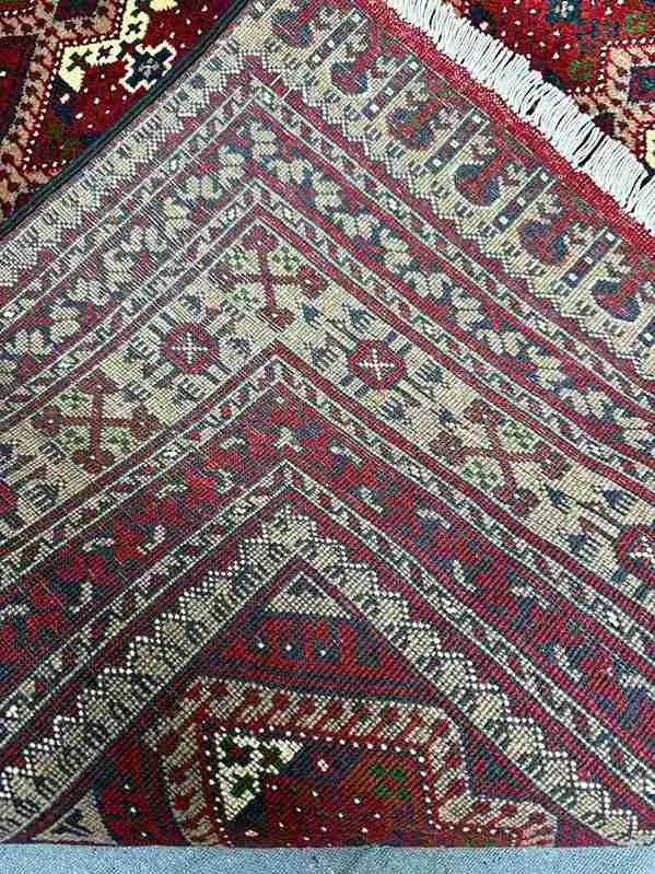 Afghan wool silk rug folded to show quality of hand-knotted craftsmanship