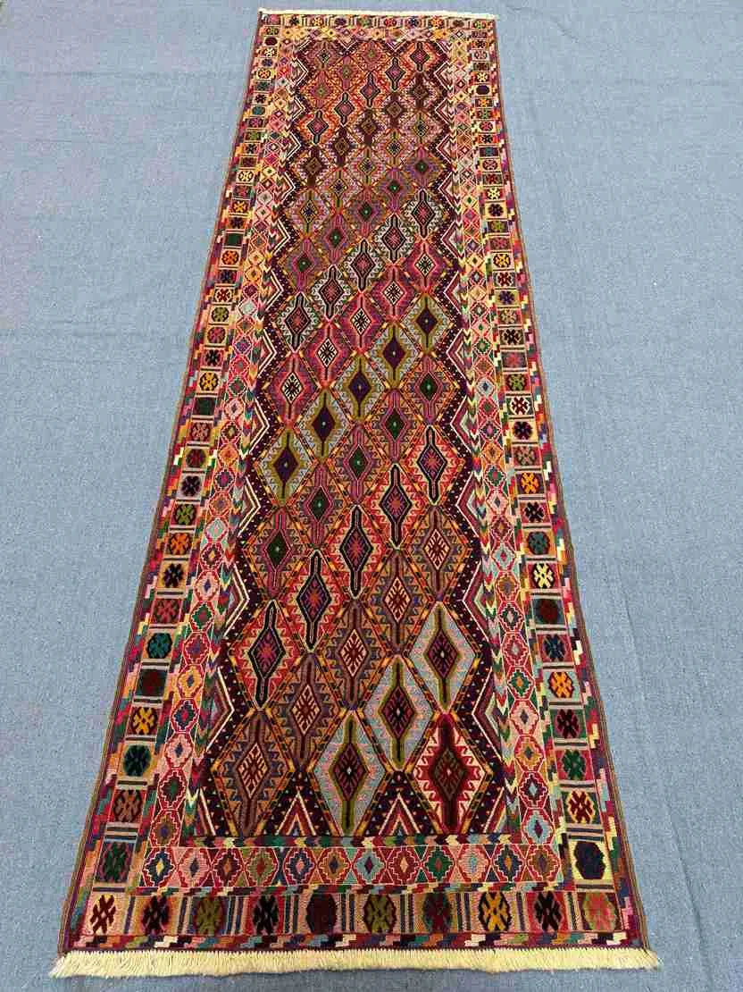 2.8x9.3 antique kilim runner rug laid on tiled surface