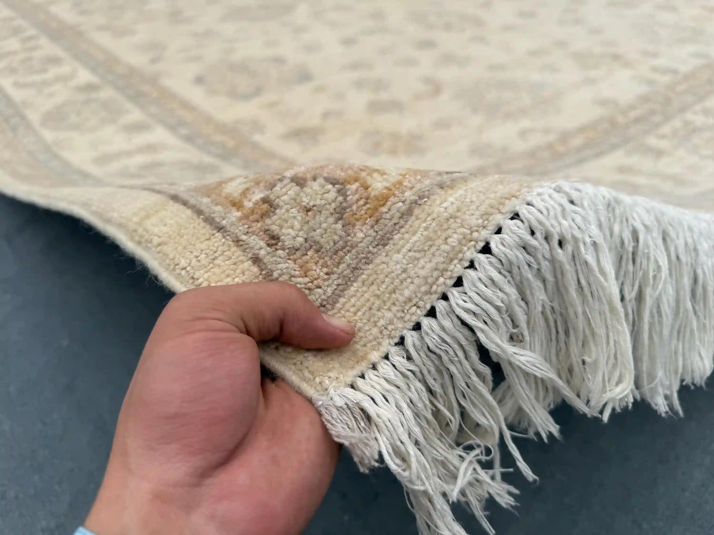In-hand view of 8x9.11 ft handmade beige & taupe Ziegler wool rug