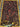 Corner detail of handmade Persian silk rug – traditional knotted design