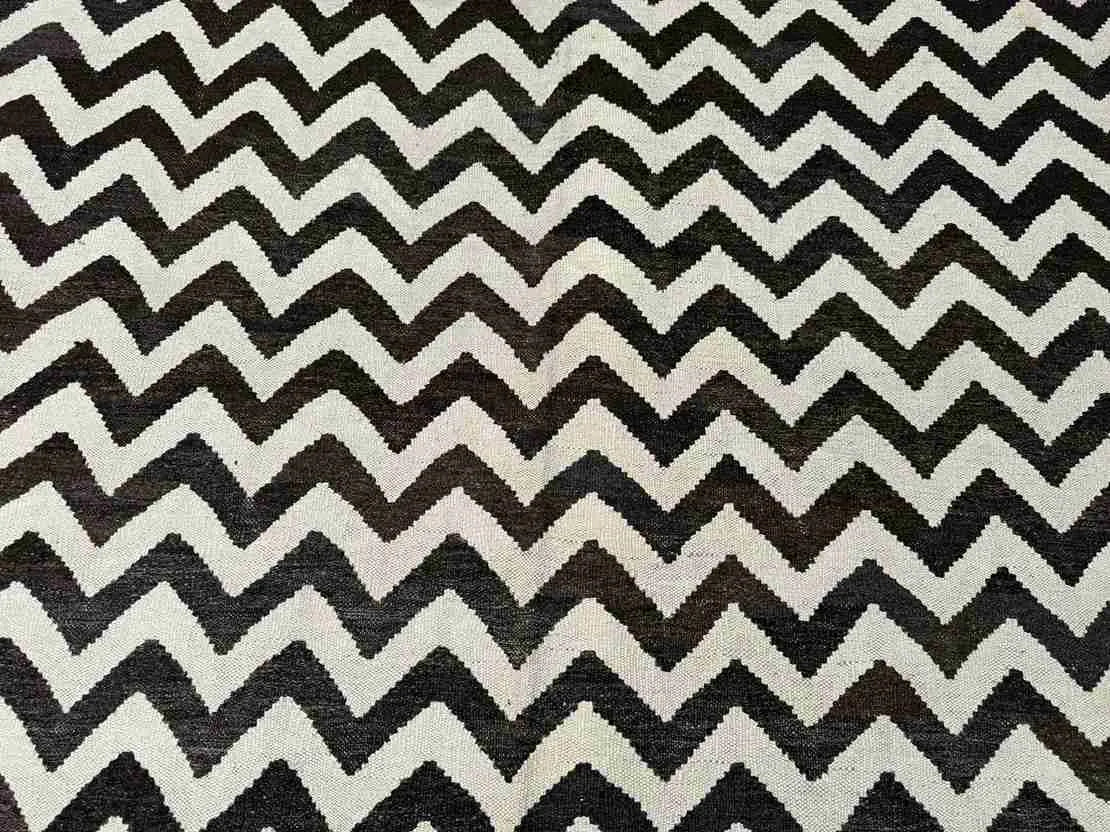 Close-up of bold geometric pattern on handmade Kilim wool rug