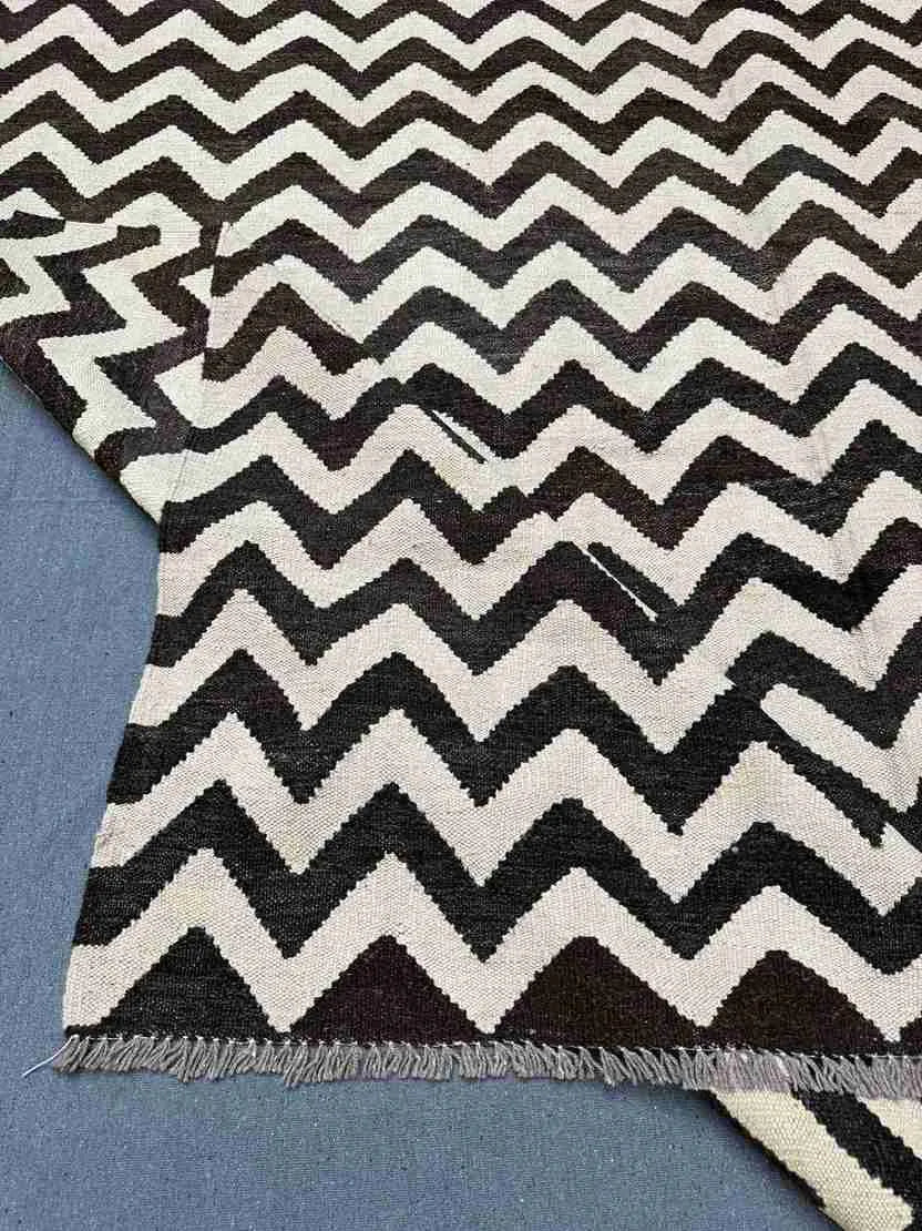 Folded Kilim rug showing flexible flatweave texture