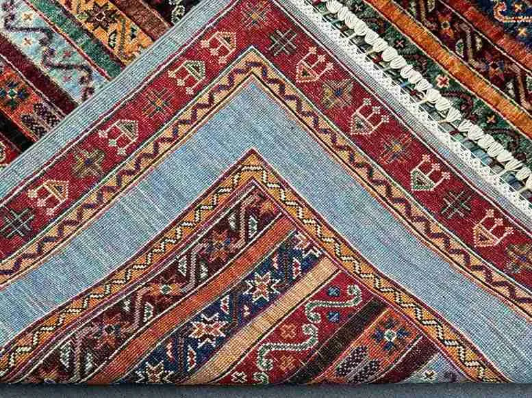 Folded view of vintage kilim carpet with nomadic boho-style patterns