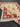 Folded view of handmade red and cream Chobi wool rug