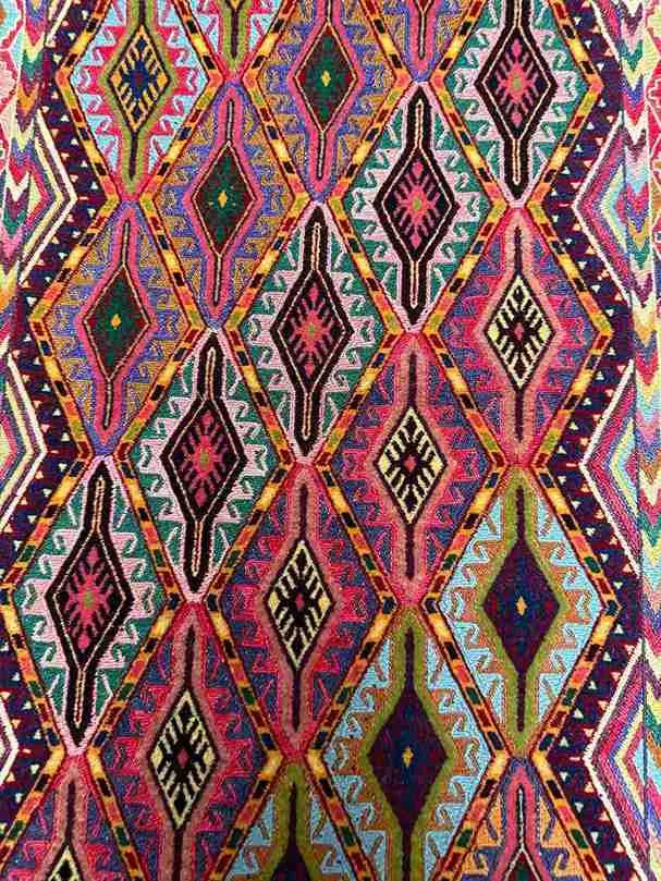 Close-up of handwoven geometric pattern on Turkish kilim wool rug