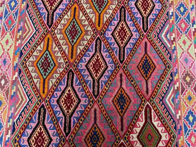 Close-up of colorful tribal pattern on Turkish kilim hallway rug