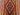 Close-up of handwoven tribal wool weave in red and orange on vintage oriental runner rug