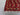 Corner detail of handmade Afghan rug in red and beige with traditional motifs