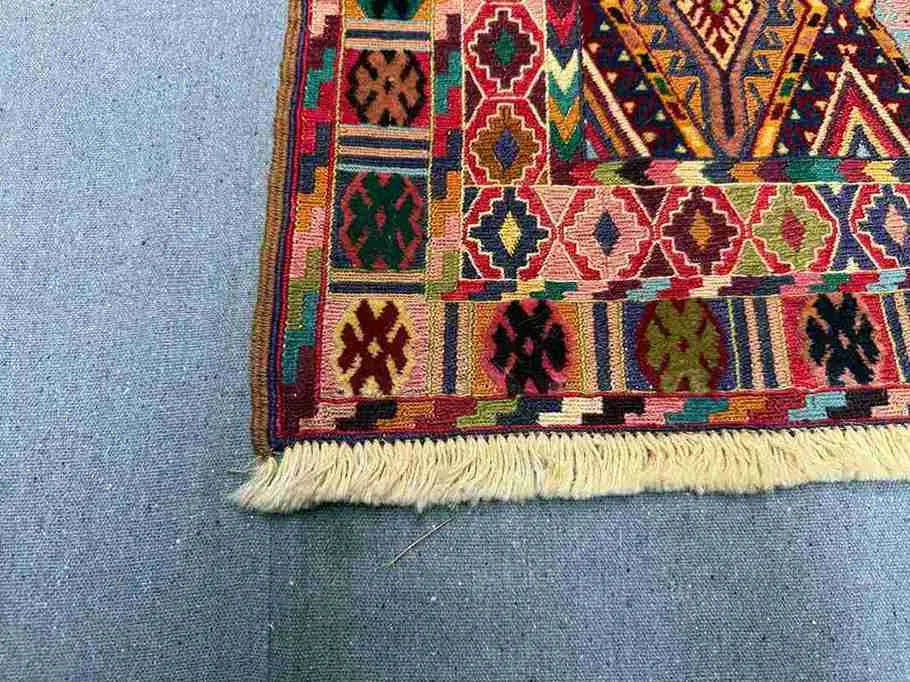 Corner detail of antique tribal kilim rug – intricate flatweave design