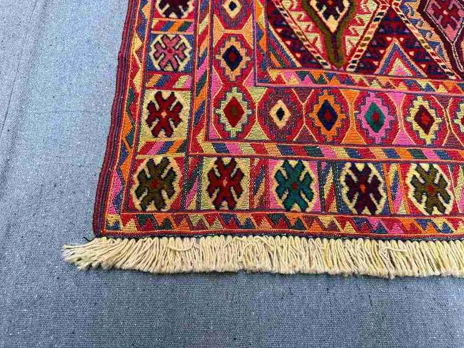 Corner detailing of handwoven antique kilim with geometric motif