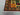 Corner detail of handmade 4x7 patchwork Oriental rug with traditional motifs