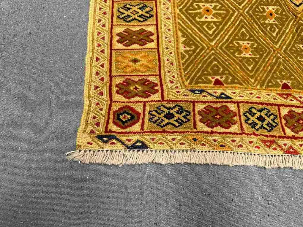 Corner weave detail of gold-accented Afghan tribal kilim rug