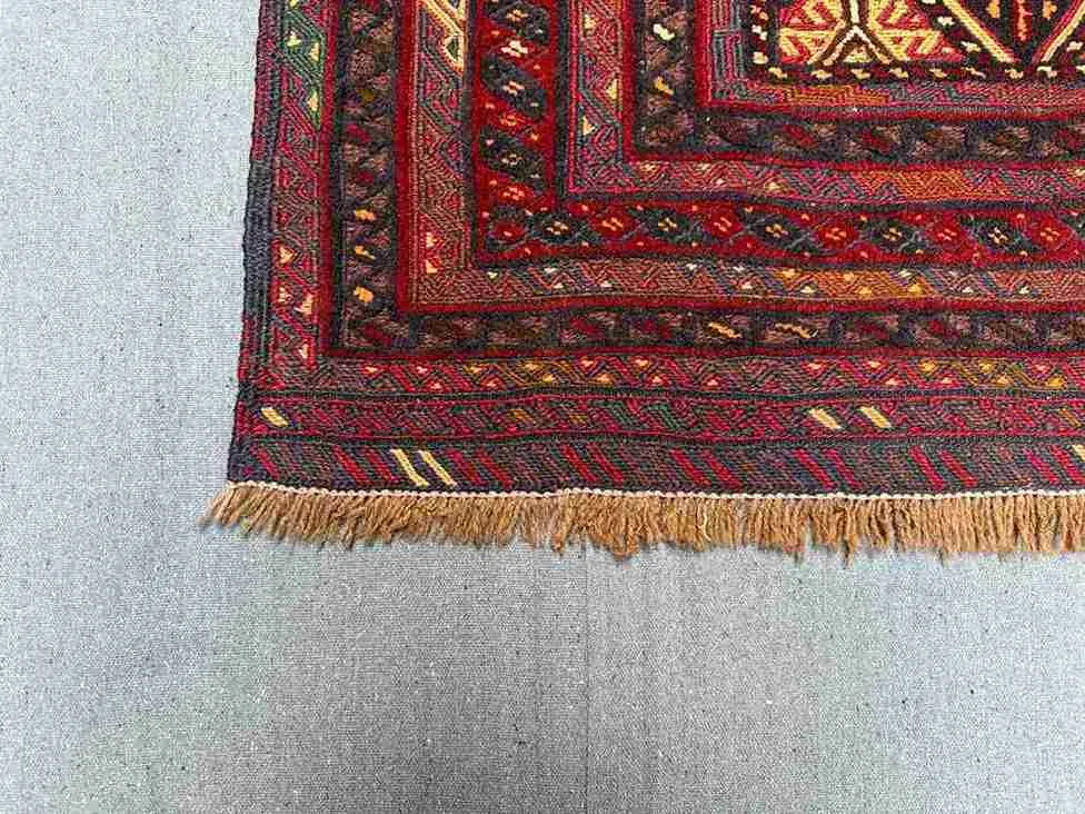 Corner view showing handwoven wool texture of nomadic kilim rug