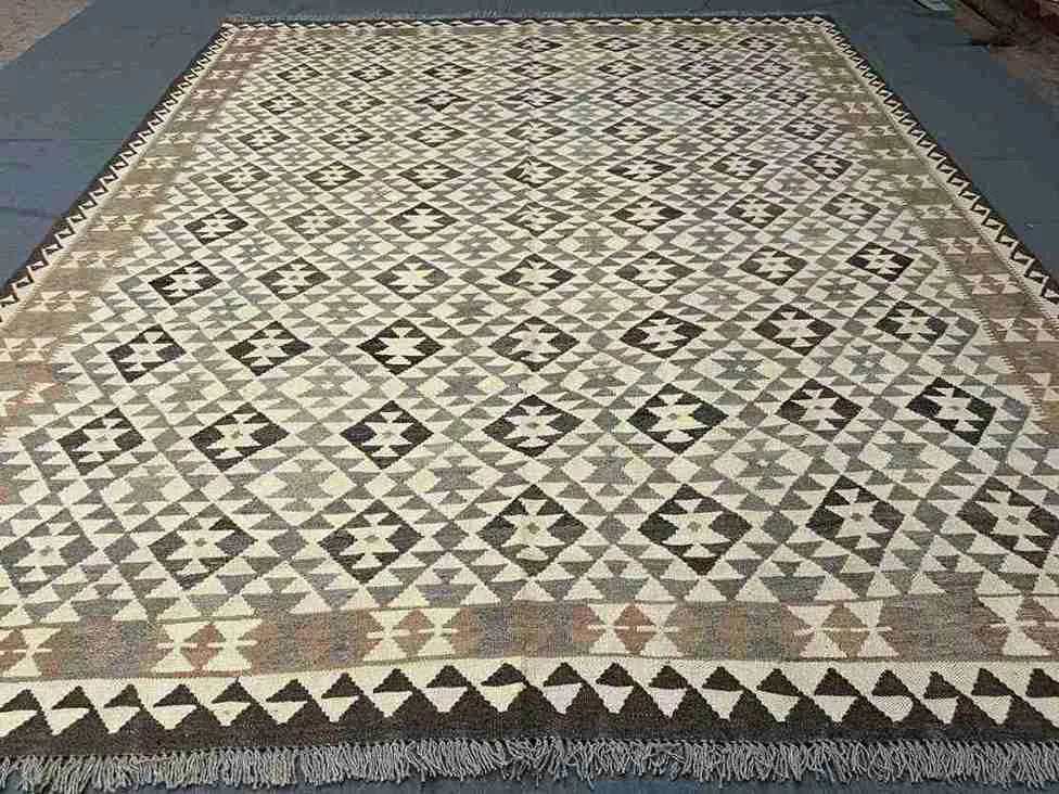 Beige and brown earth-tone Kilim rug close-up – 8x10 size with traditional geometric design.