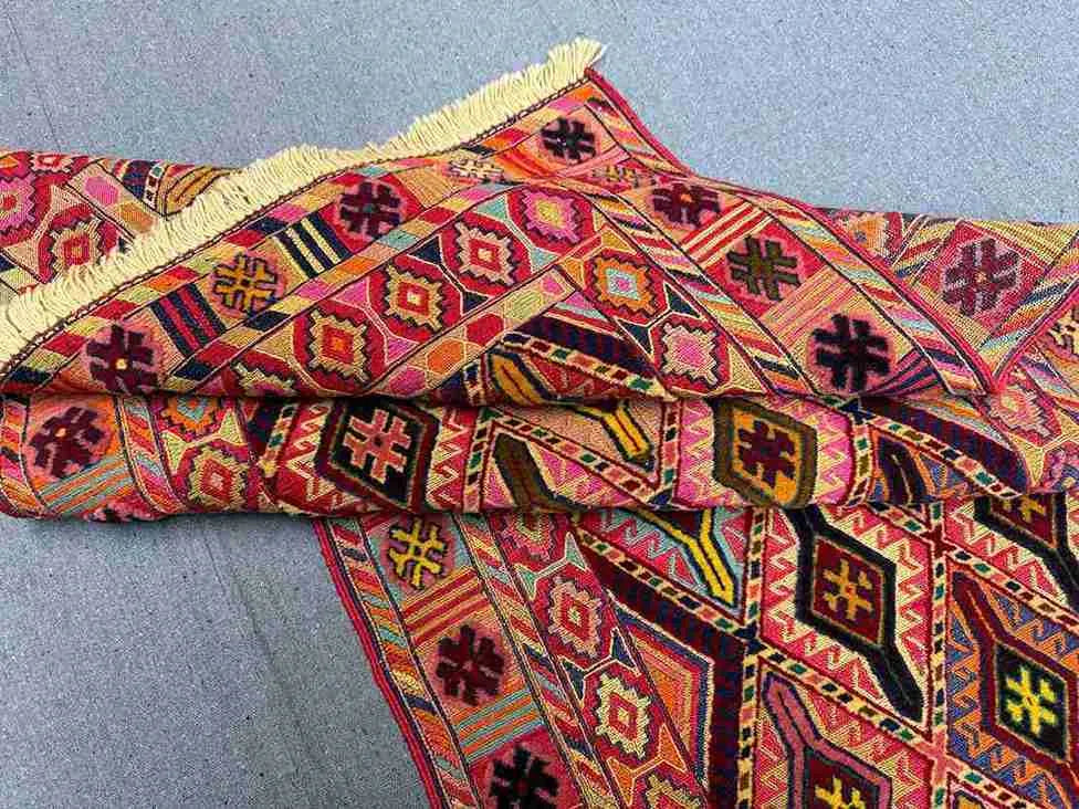Folded view of vintage wool Kilim runner rug
