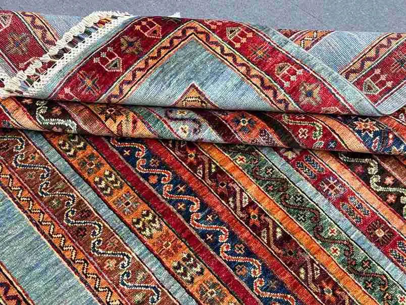 Folded Turkish kilim showing wool texture and striped floral design