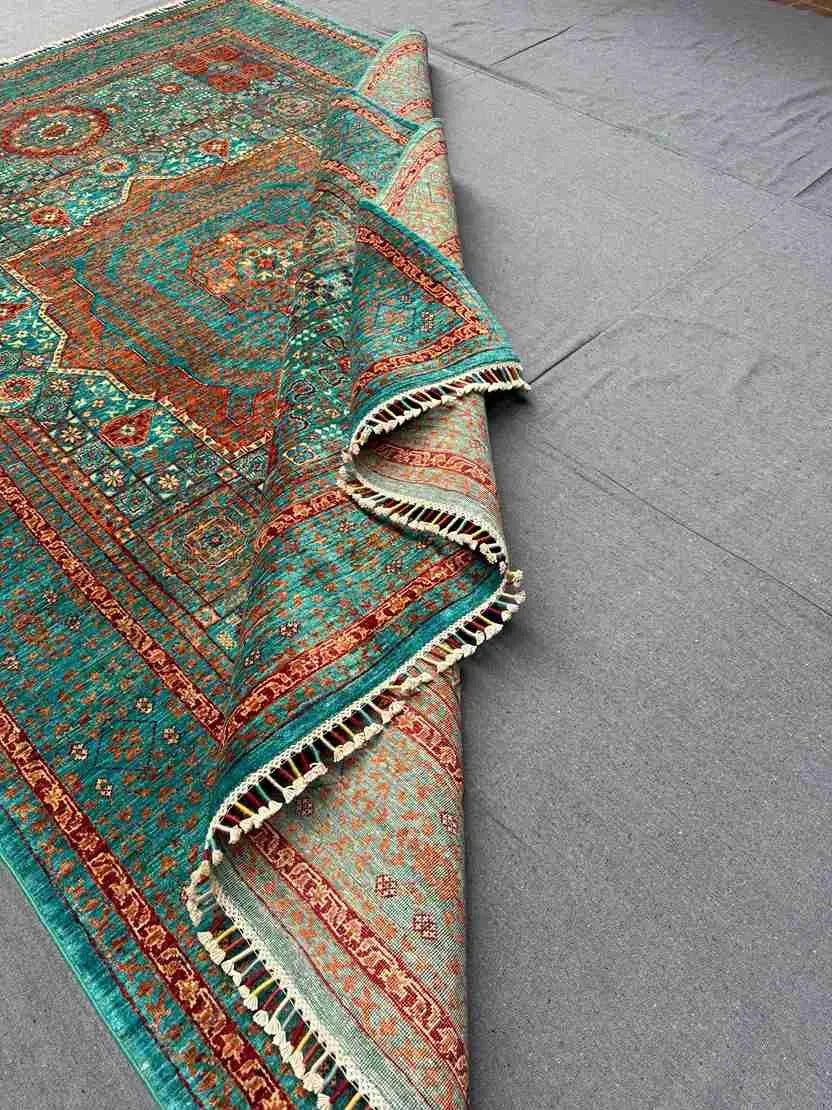 Folded side view of hand-knotted wool silk Mamluk rug
