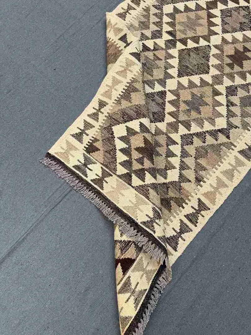 Folded wool Turkish runner rug – flatweave texture and artisan detail.