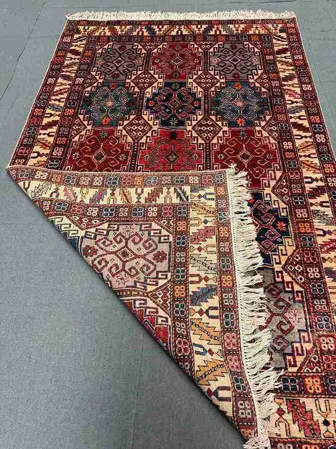 Folded view of handmade 5x7 Waziri rug showcasing quality wool