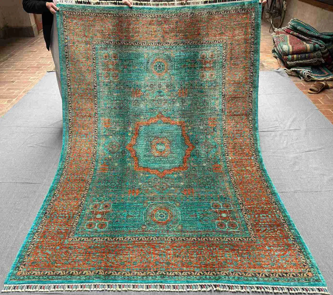 Full top view of Turkish handmade 6x8 Mamluk rug in green, orange, and turquoise