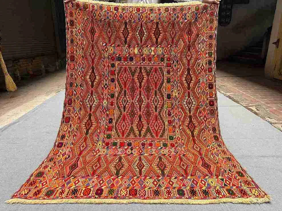 Full top-down view of 4.9x6.6 Turkish Afghan kilim rug with geometric tribal design in red and orange