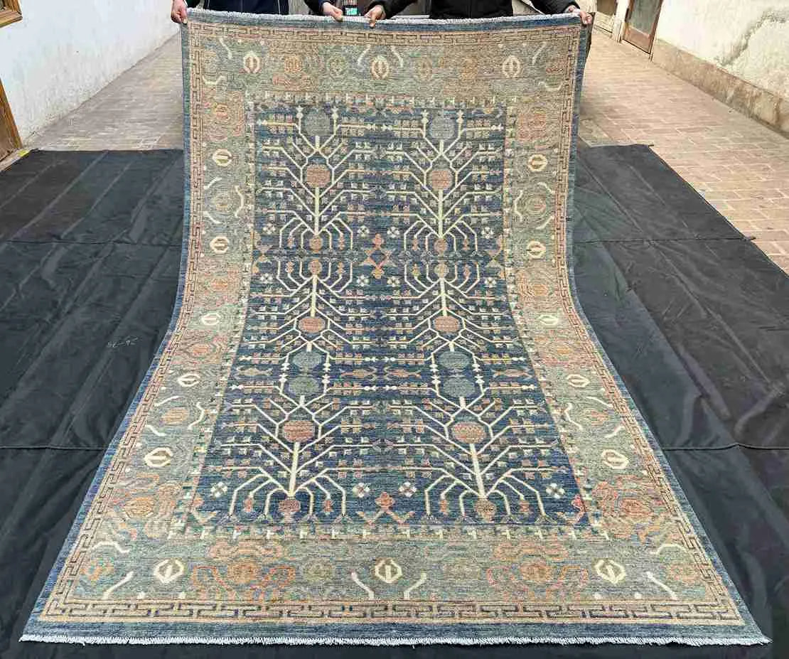 Full overhead view of handmade 5x9 blue and beige wool Tree of Life rug