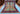 Full view of 8x10 handmade Oriental rug in red, blue, turquoise, and orange