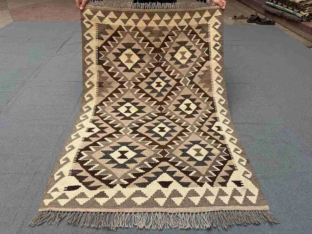 Full view of small handmade Turkish Kilim rug – traditional flatweave with tribal motifs.