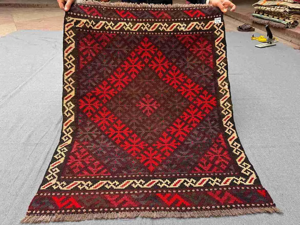 Full view of handwoven small red Afghan Kilim rug – geometric wool flatweave accent carpet.