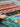Handmade Gabbeh wool rug held in hands showing front tribal pattern