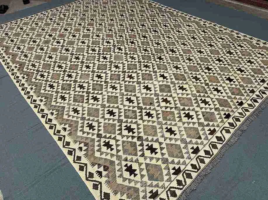Geometric Turkish Kilim carpet styled in a cozy living space – hand-knotted earthy flatweave.