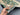 Close-up of hand holding wool Persian Ziegler rug – authentic handmade detail
