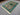 Green and turquoise artisan rug decorating contemporary floor space