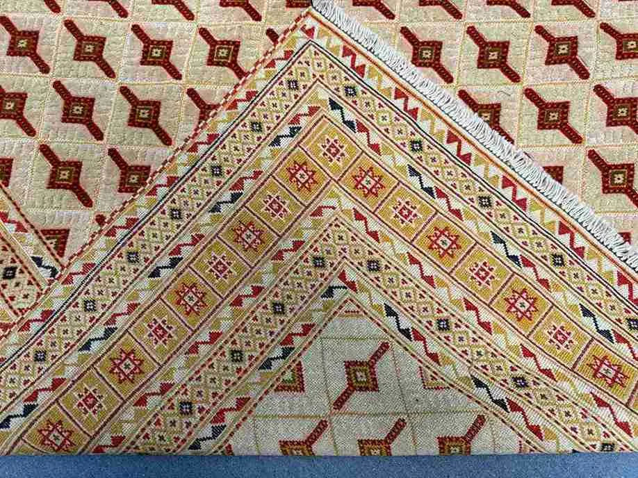 Half-folded Persian Afghan kilim showing handwoven thickness