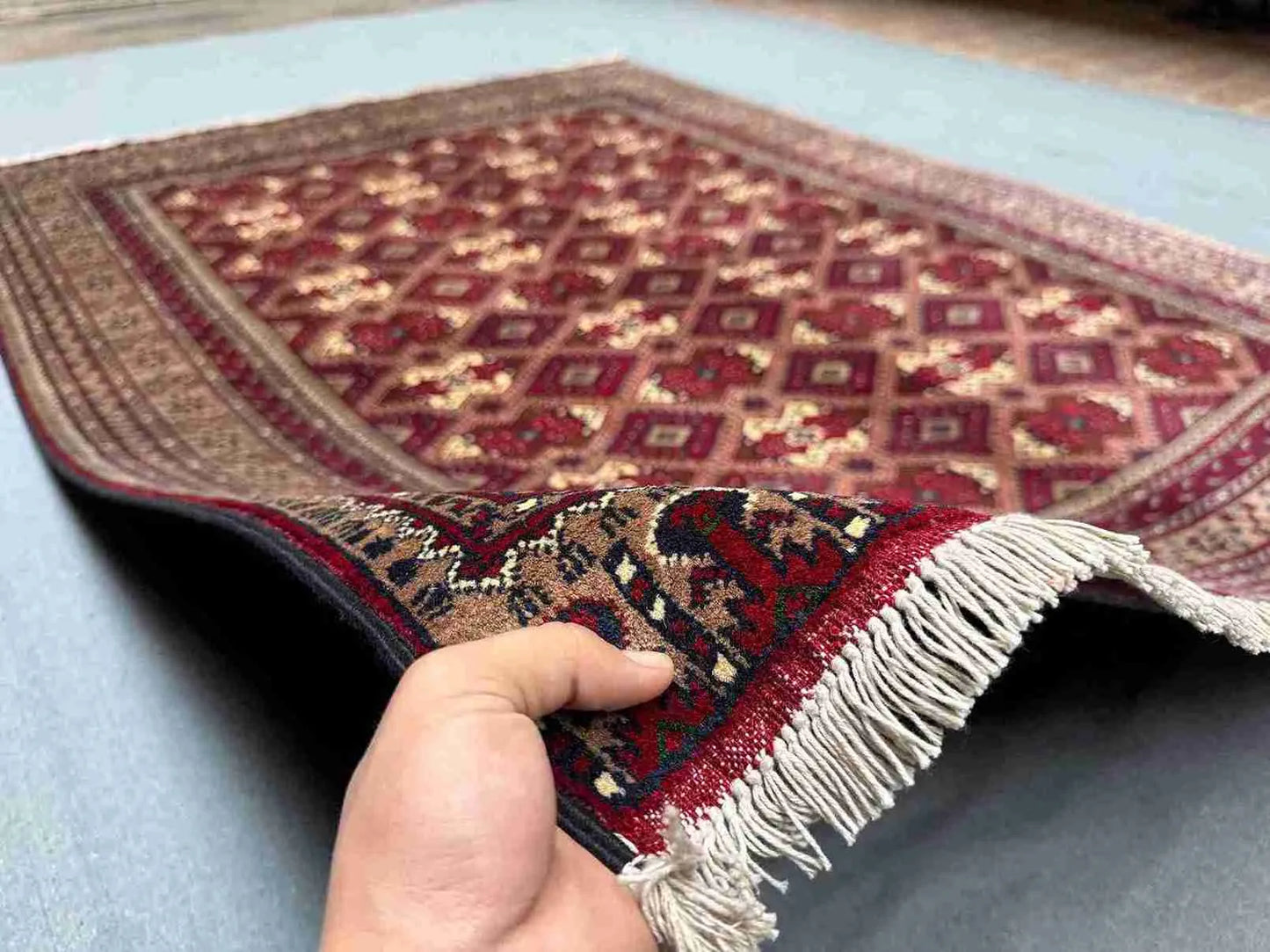 Handmade 5x7 Afghan rug in hands – red and beige wool silk Turkish carpet