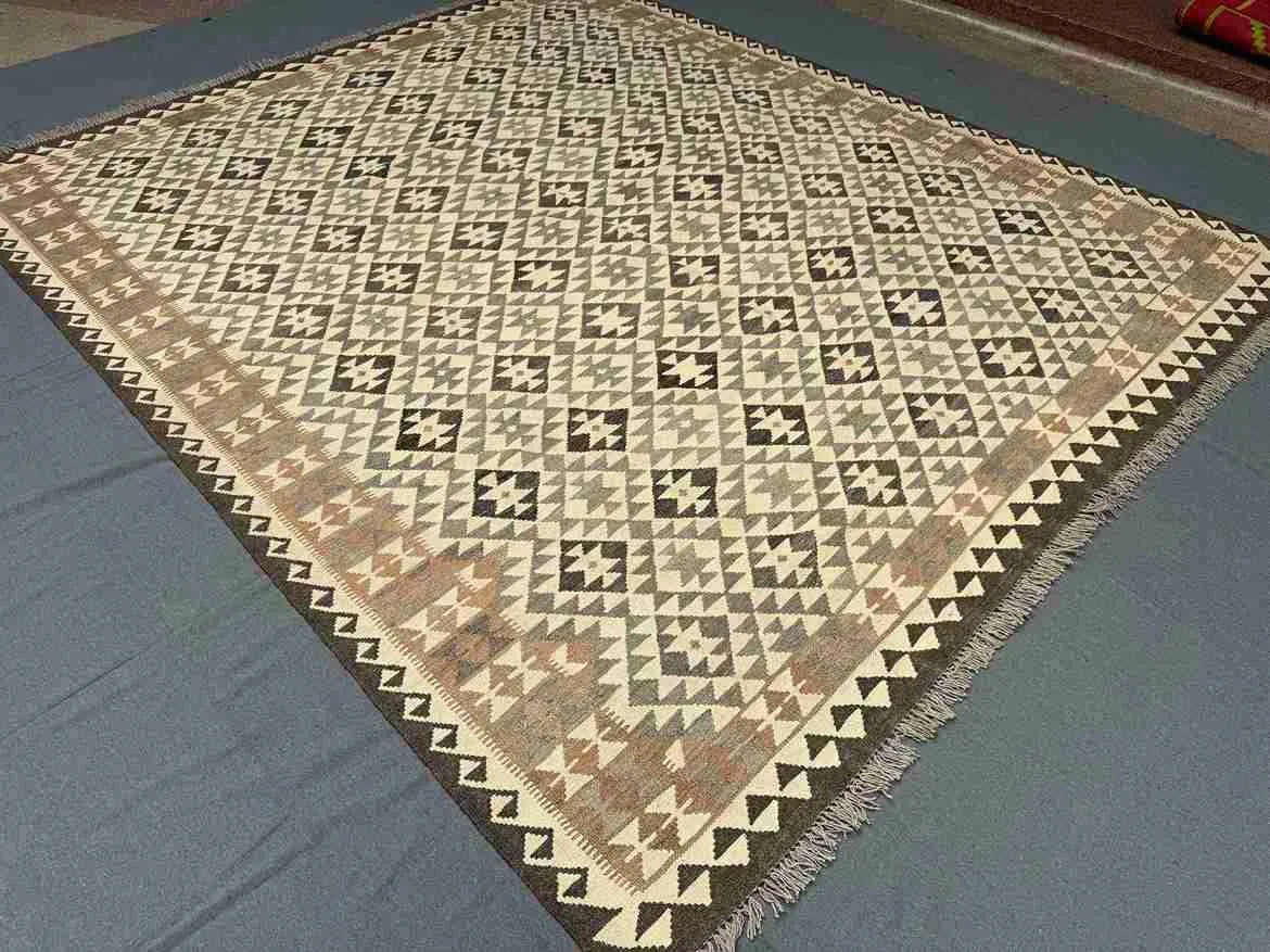 Handmade geometric Turkish rug styled on floor – knotted wool with earthy tones.