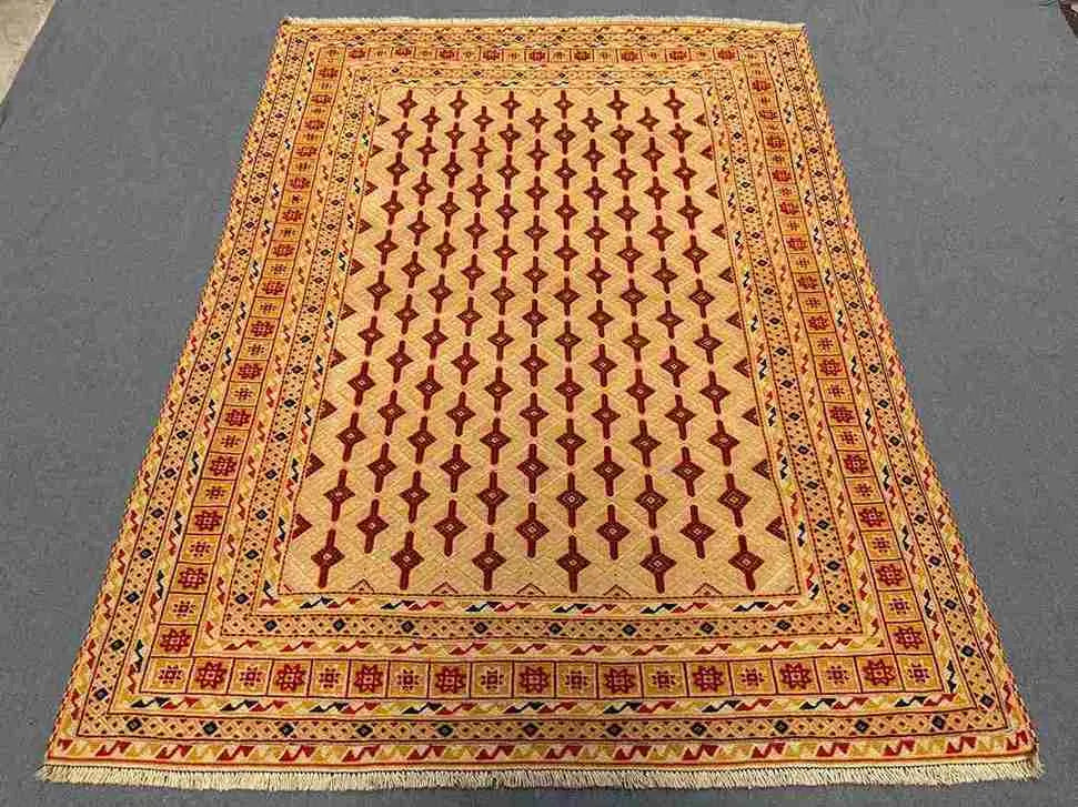 Handmade Afghan rug styled on hardwood floor for home interior